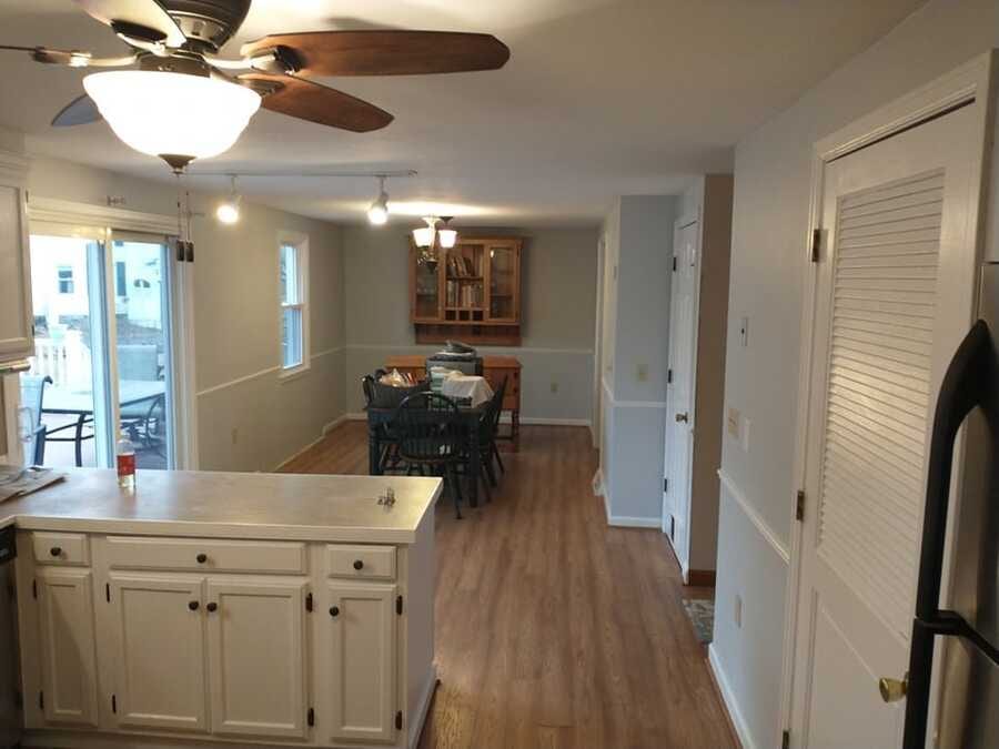 Finished kitchen and dining interior with freshly painted light cabinets and walls