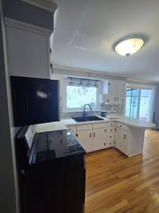 Interior kitchen with painted cabinetry and bright counters
