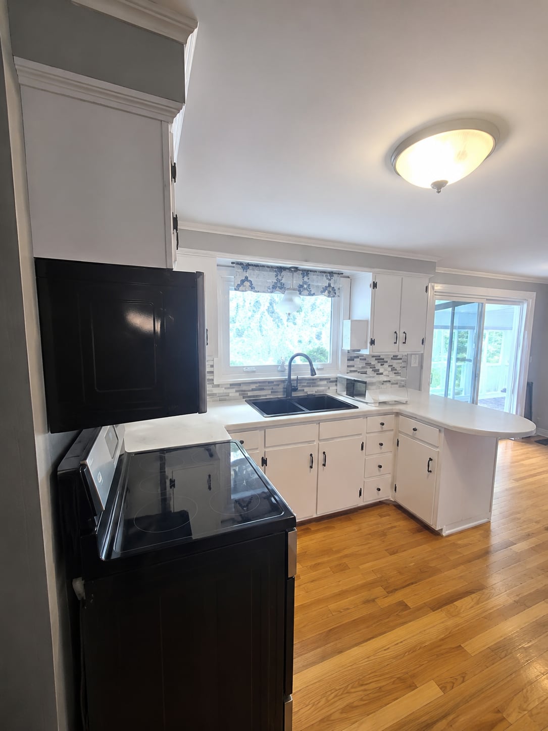 Kitchen cabinet painting project with refreshed cabinetry, trim, and dining area finishes